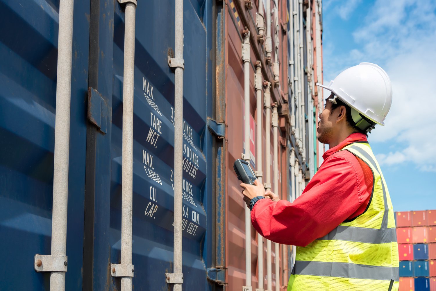 Foreman control loading Containers box from Cargo freight ship