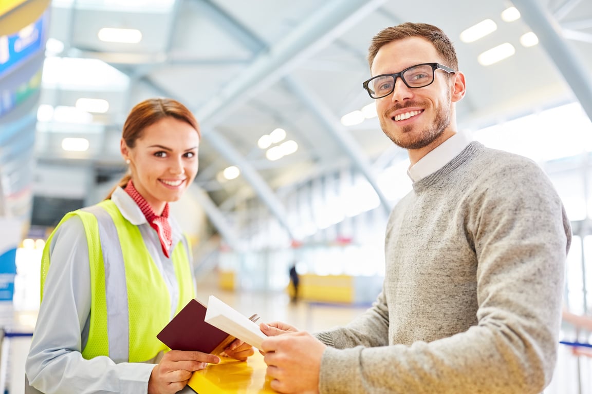 Smiling Man as a Passenger with Airport Staff